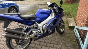 motocykl stoi chodniku, z tyłu widać radiowóz